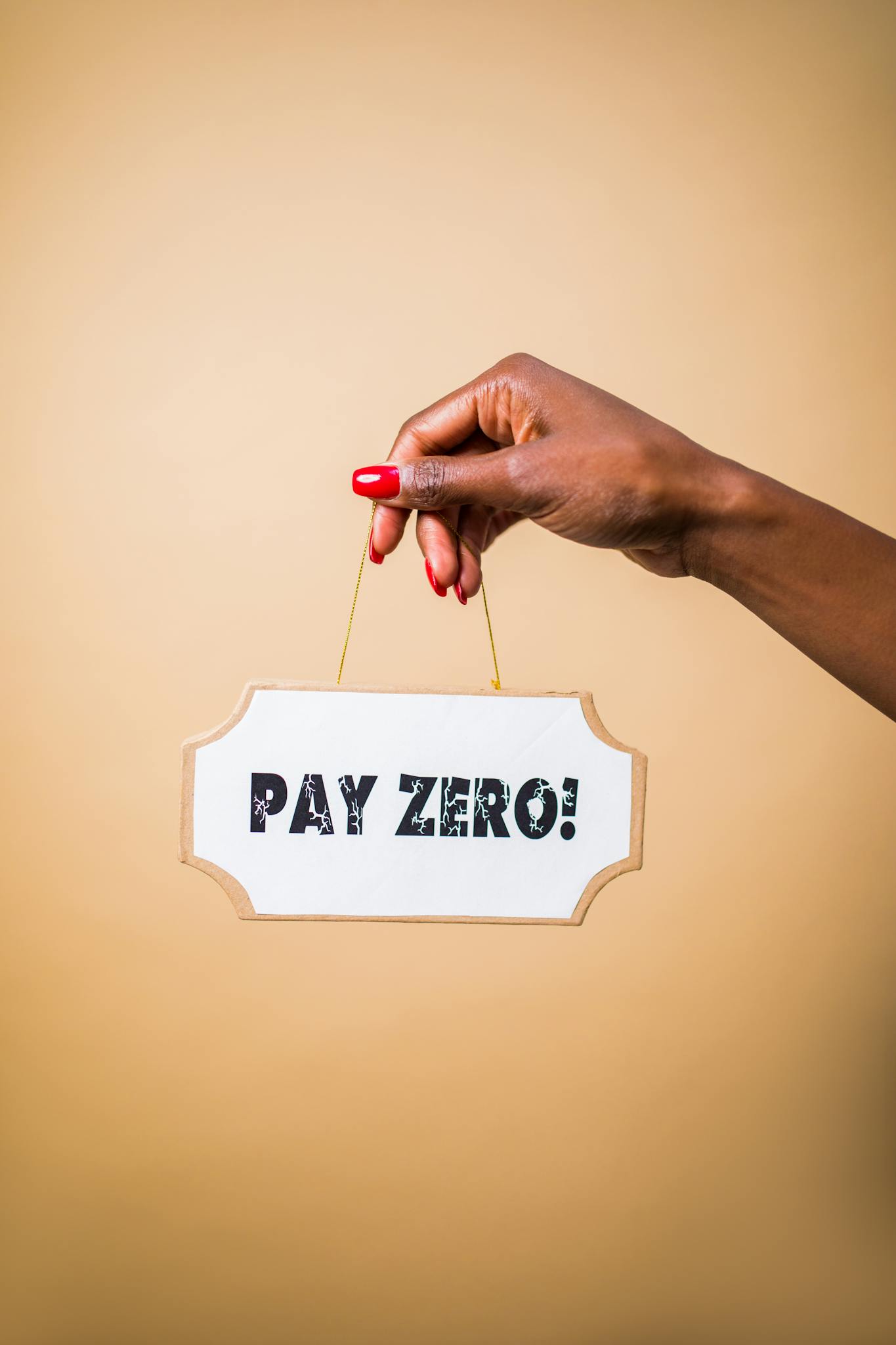 A hand holds a 'Pay Zero' sign, symbolizing cost savings or free content.
